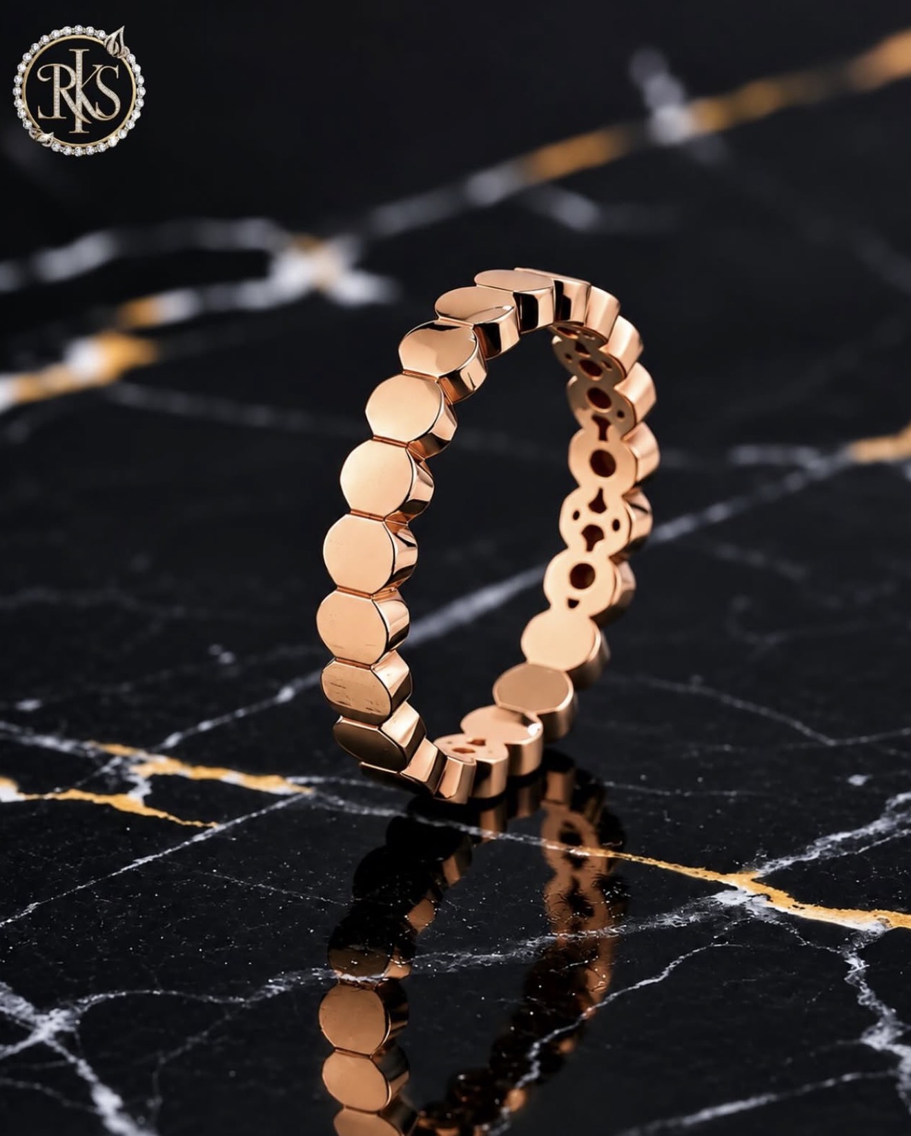 Gold link ring on dark marble — Ramesh Kapoor & Sons Jewellers
