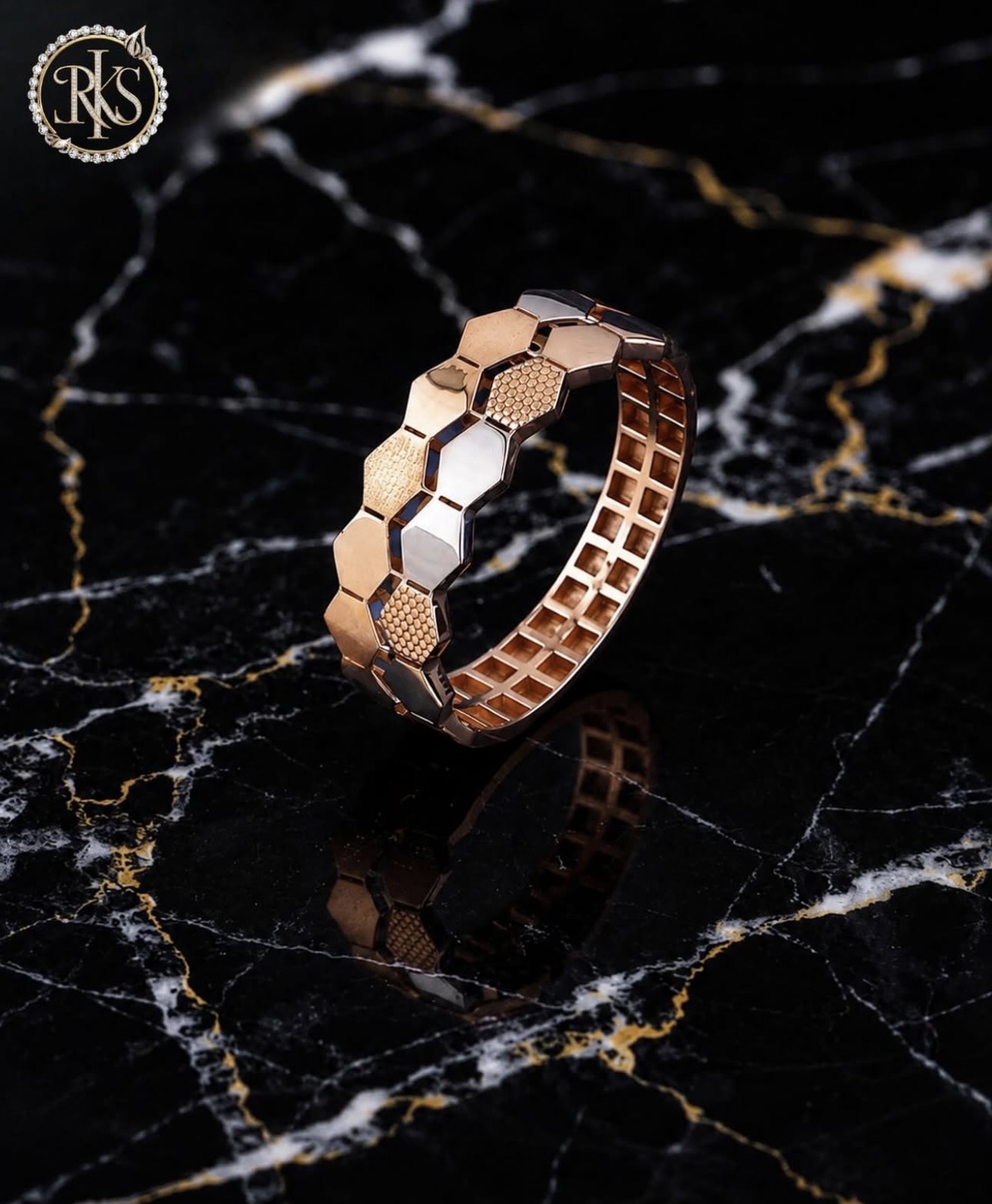 Two-tone hexagonal link bangle on dark marble — Ramesh Kapoor & Sons Jewellers